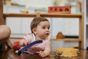 Montessori infant girl playing musical bells