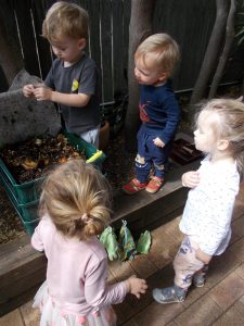 Children looking at a worm farm.