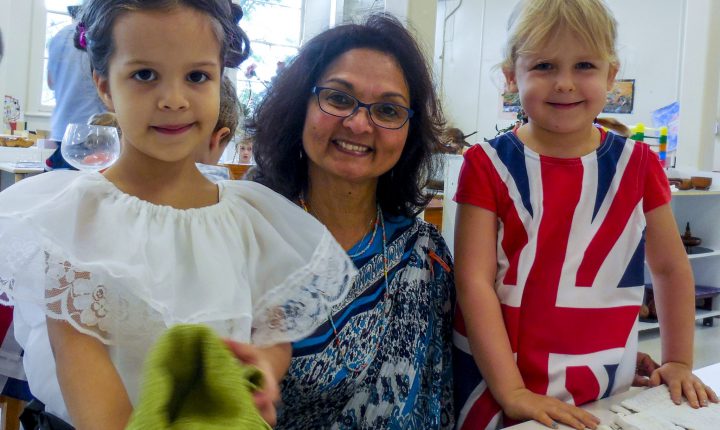 Montessori children and Director in multicultural dress.