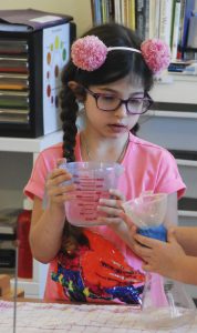 Child conducting an air blocks passage experiment.