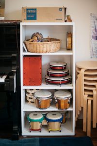 Display of drums on shelves.