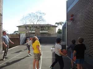 Children playing basketball at Montessori Balmain.
