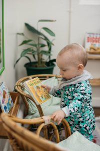 Infant looking at a book