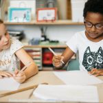 Montessori children problem solving through collaborating.