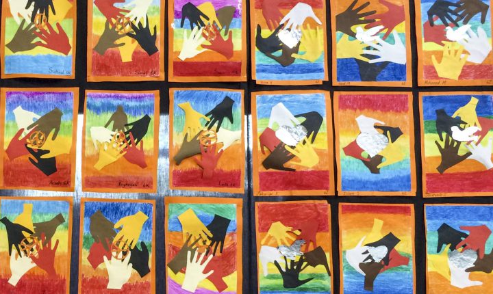 Hands of different colours representing peace.