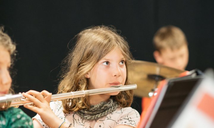 Montessori child playing the flute.