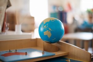 A globe of the world and a world puzzle.